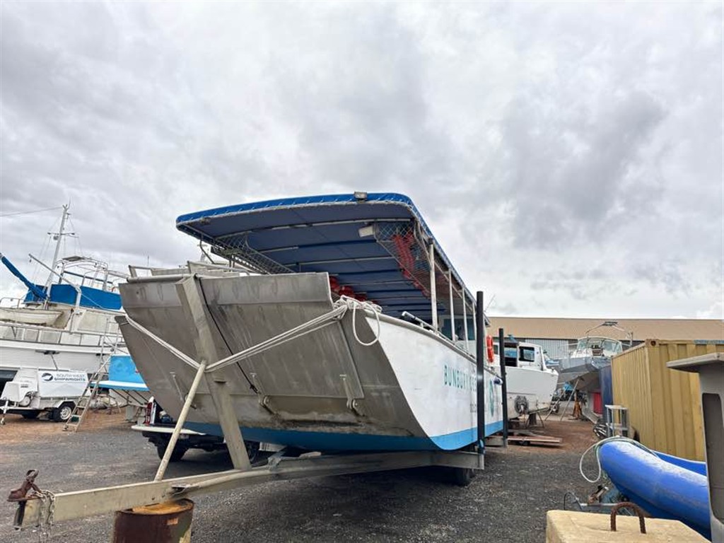 Dive charter vessel on trailer in a shed