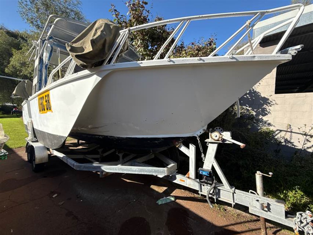 Survey boat on trailer in a driveway